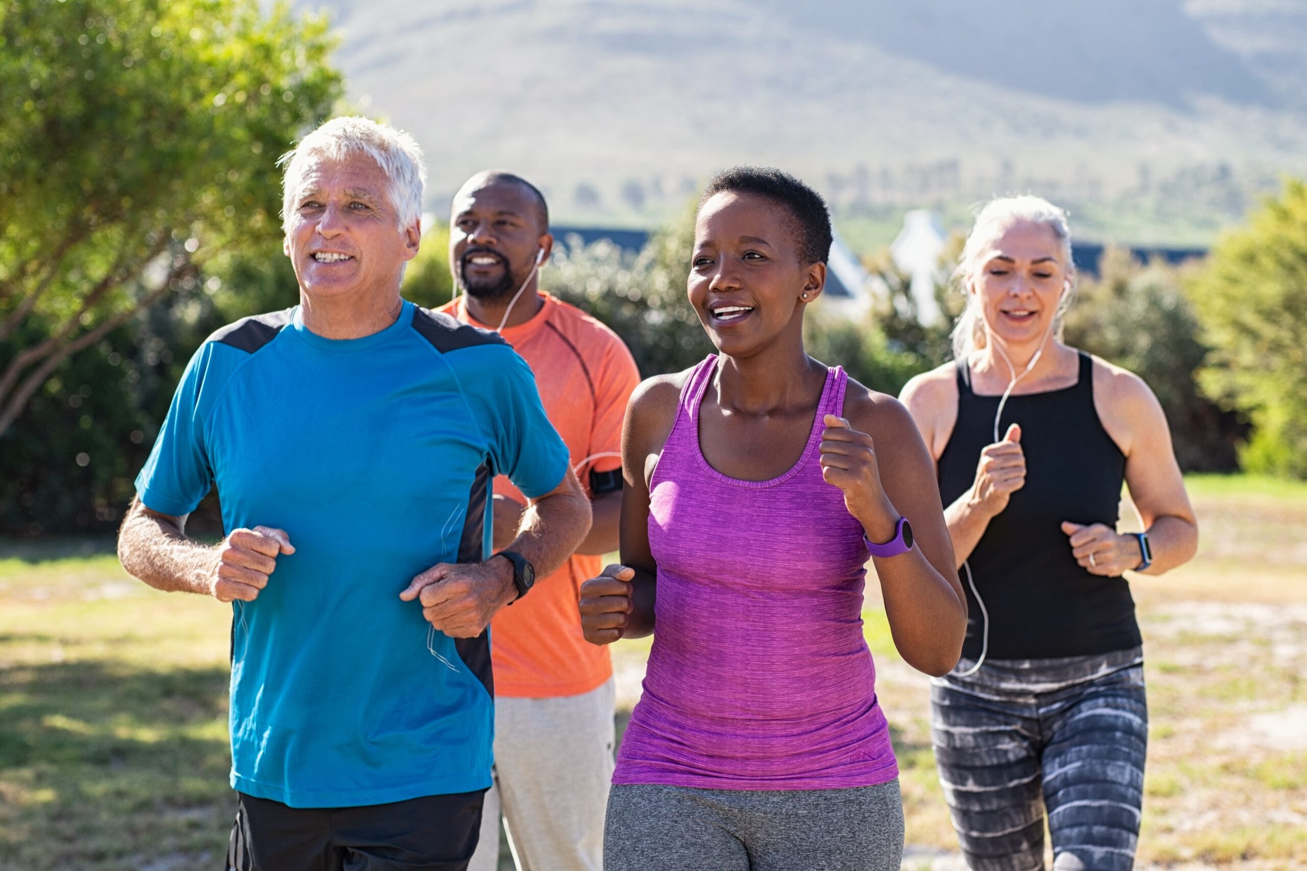 Group of mature adults jogging together outdoors
